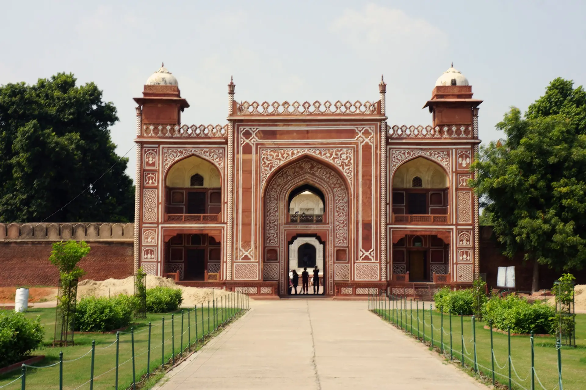 a large red building with two people standing in front of it