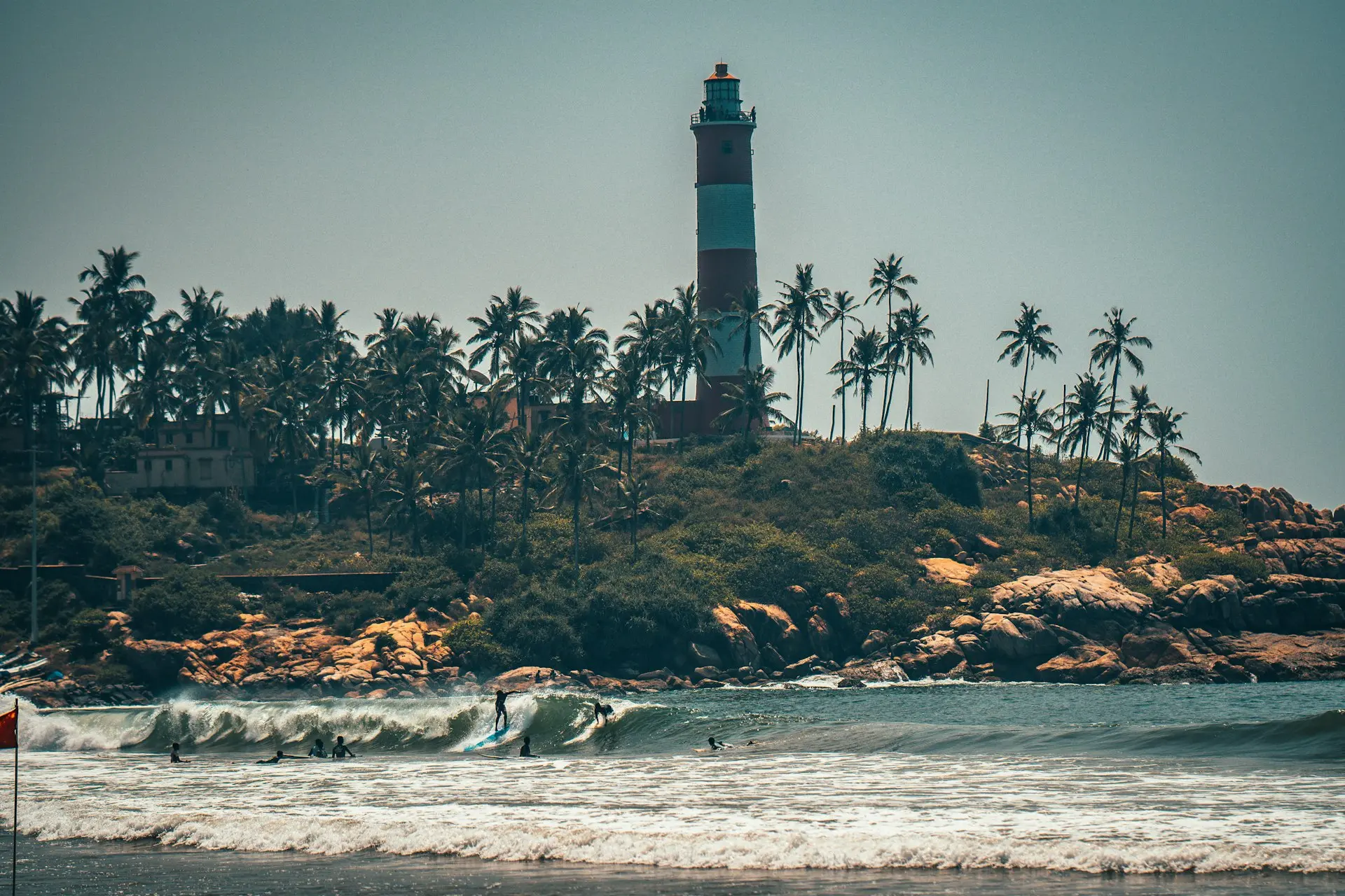 Scenic view of the Kovalam Lighthouse Beach in Kerala—ideal for budget international trips, relaxing group tours from India, and honeymoon travel packages.
