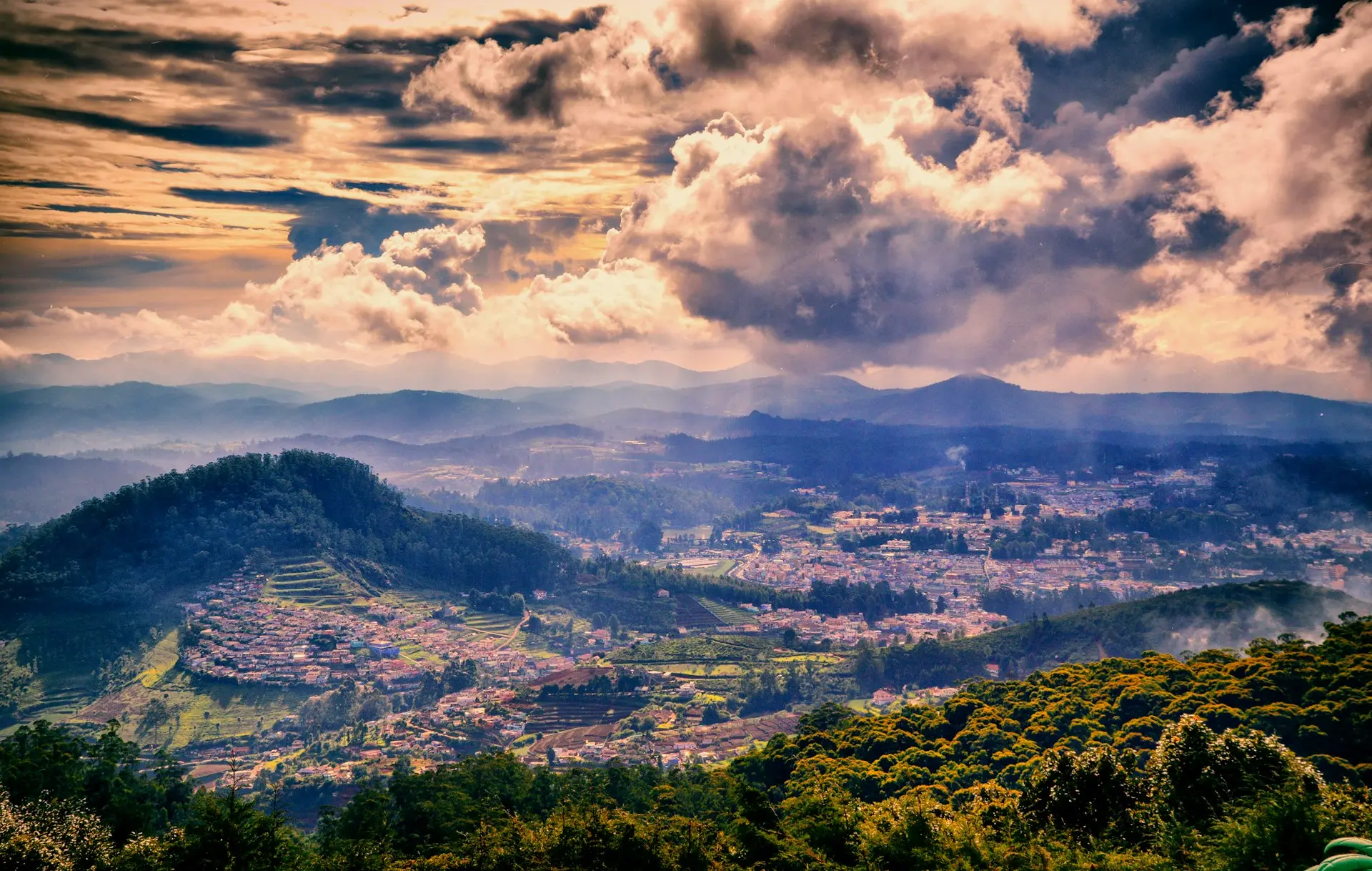 green trees on mountain under white clouds during daytime