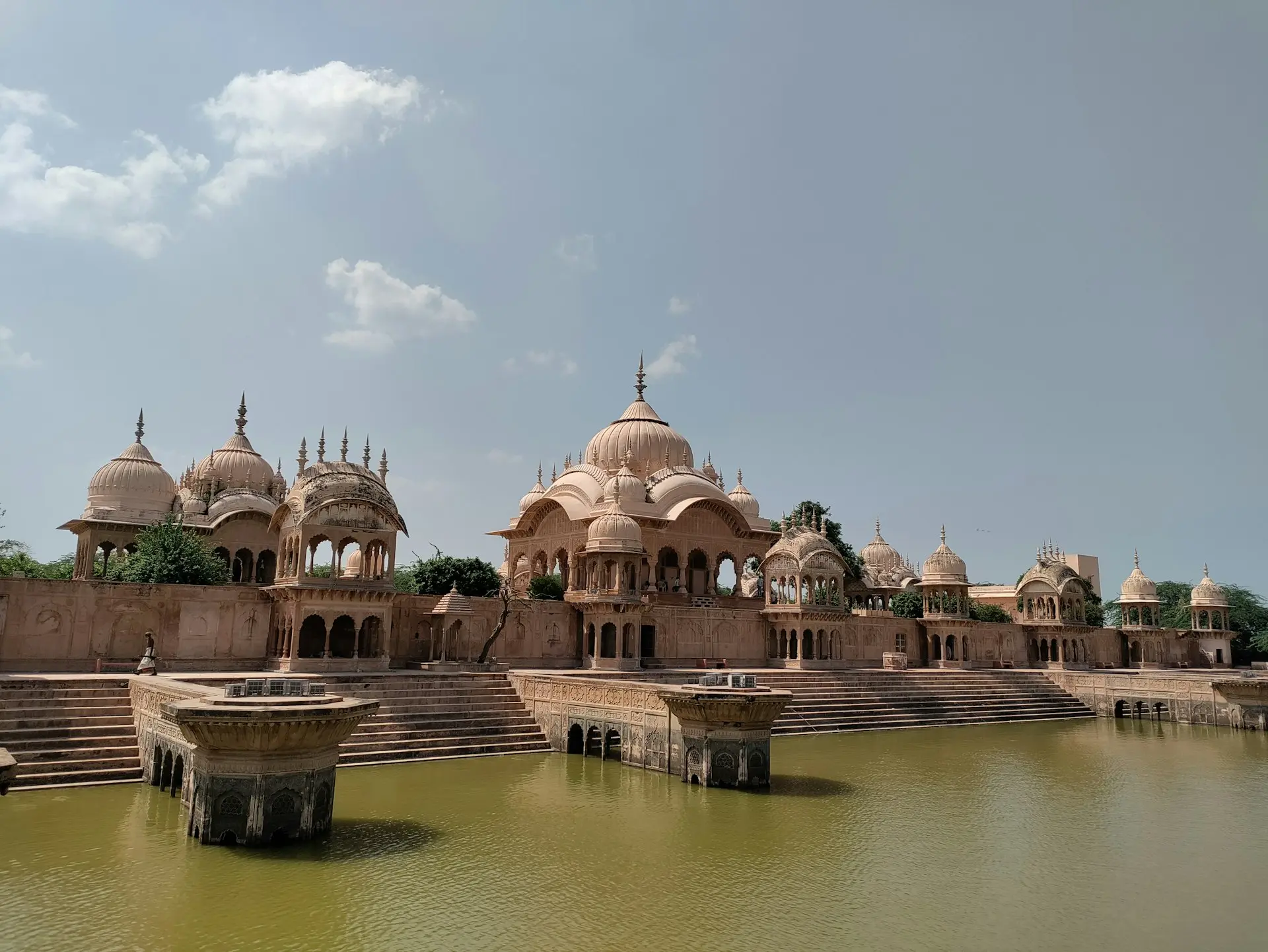 a body of water with a building in the background
