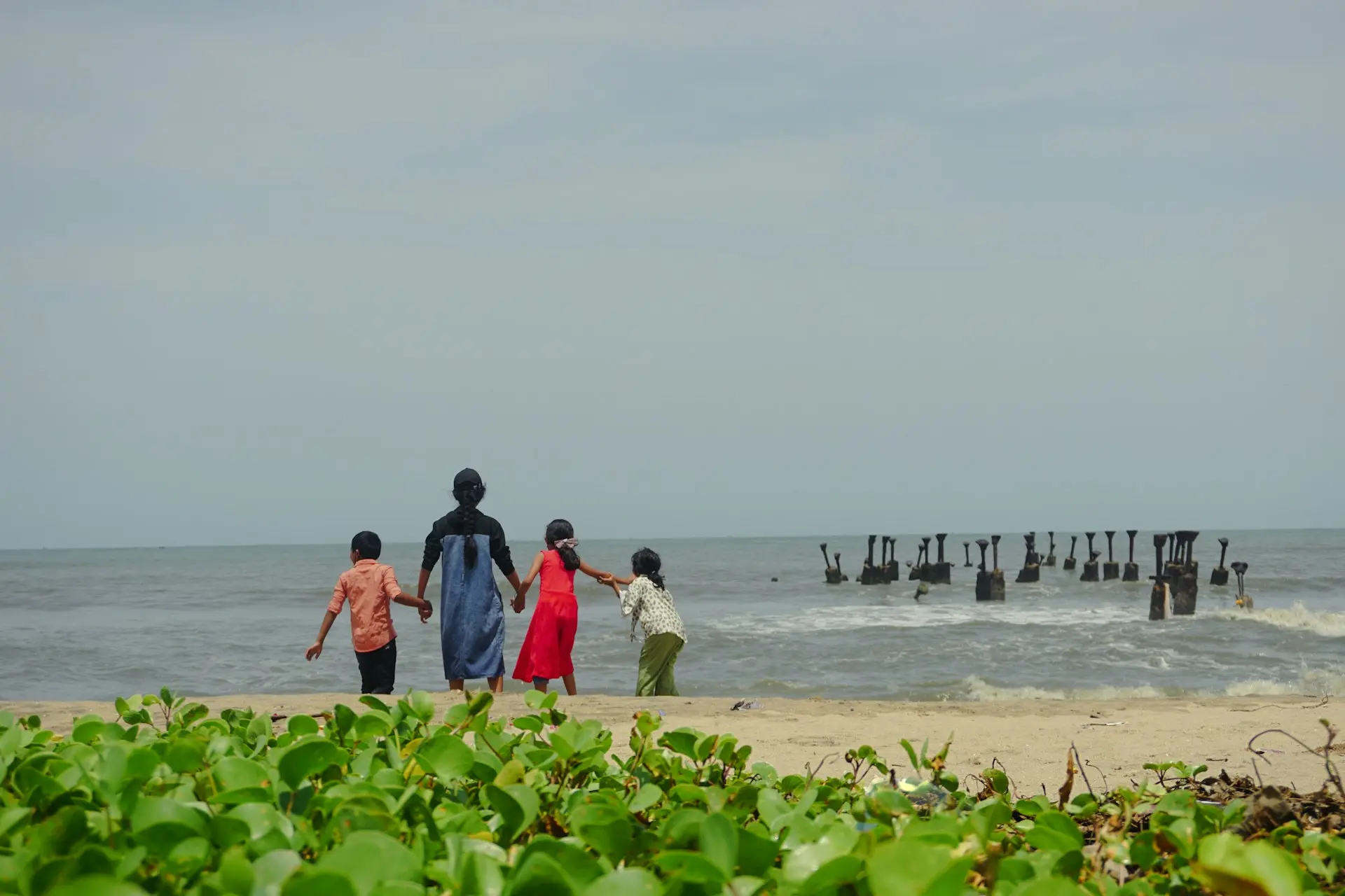 a group of people walking on a beach