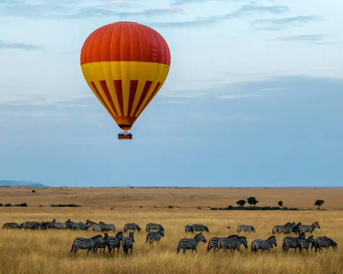 Hot air balloon flying over the savannah during Kenya safari in Masai Mara